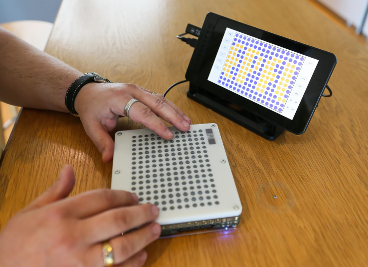 A user interacts with the BlindPad interface 