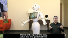 Pepper, a humanoid robot with a screen on her chest, interacts with her friend.